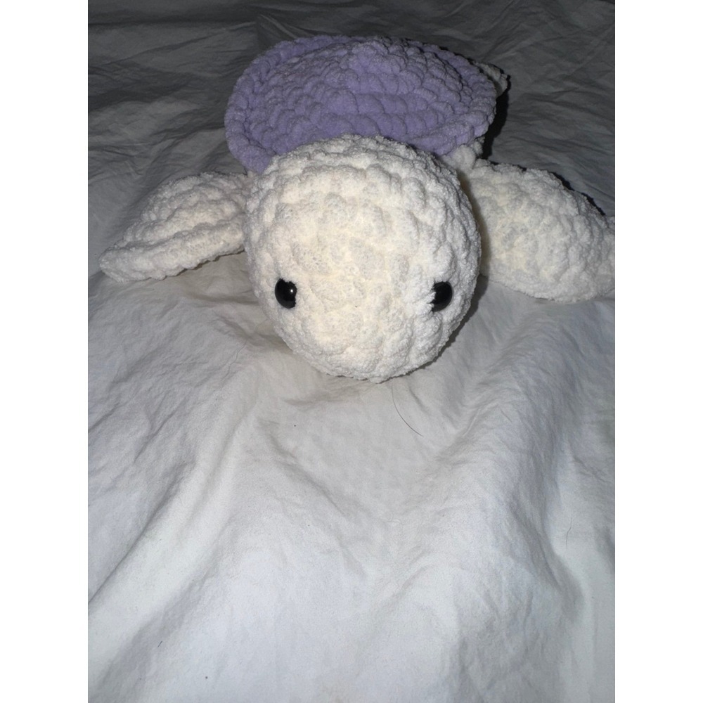 Hand crocheted baby sea turtle white body and lilac purple shell.